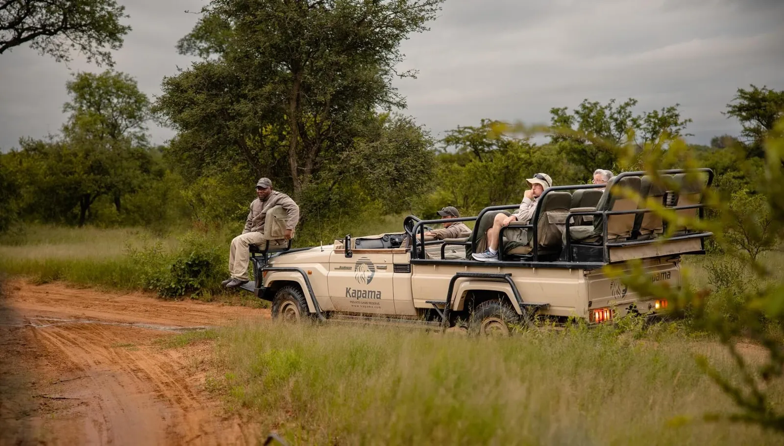 Kapama safari vehicle and guides on a bush track