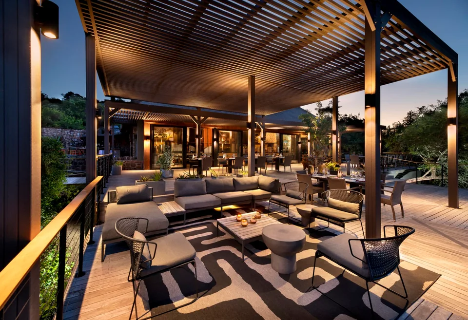 Bayethe lodge terrace and lounge lit at dusk