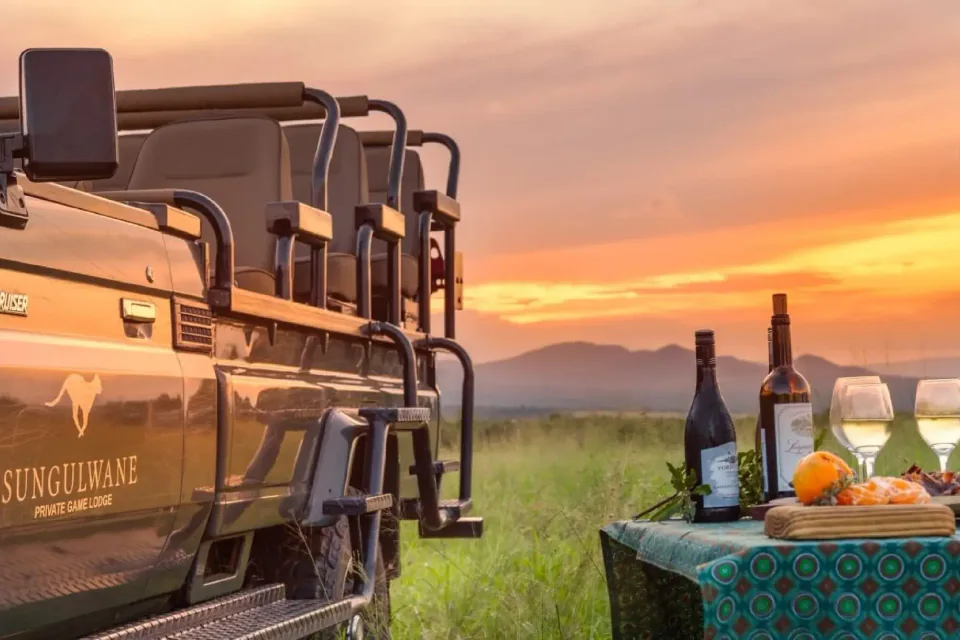Sungulwane safari vehicle and sundowner drinks at sunset
